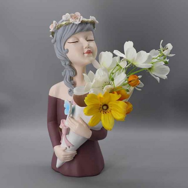 Decorative art-craft of girl with flower stand to decorate homes and shops
